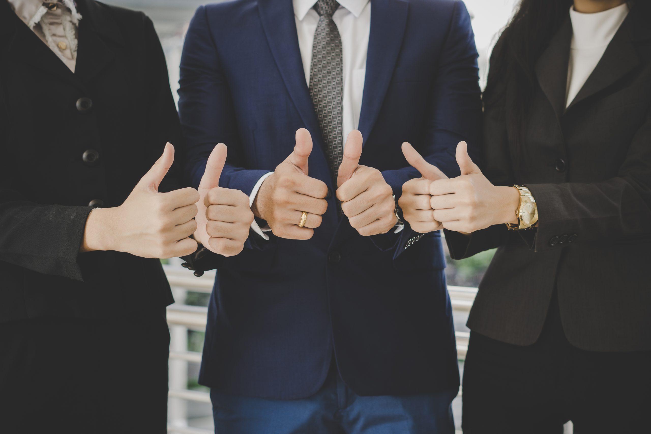 Business team standing in front of office successful business wi Business team standing in front of office successful business with showing thumbs up