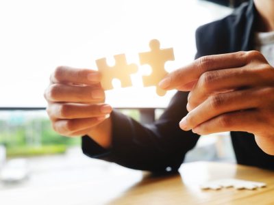 img31 Businessman hands connecting jigsaw puzzle. Business solutions, success and strategy, learning concept. Close up photo with small dof